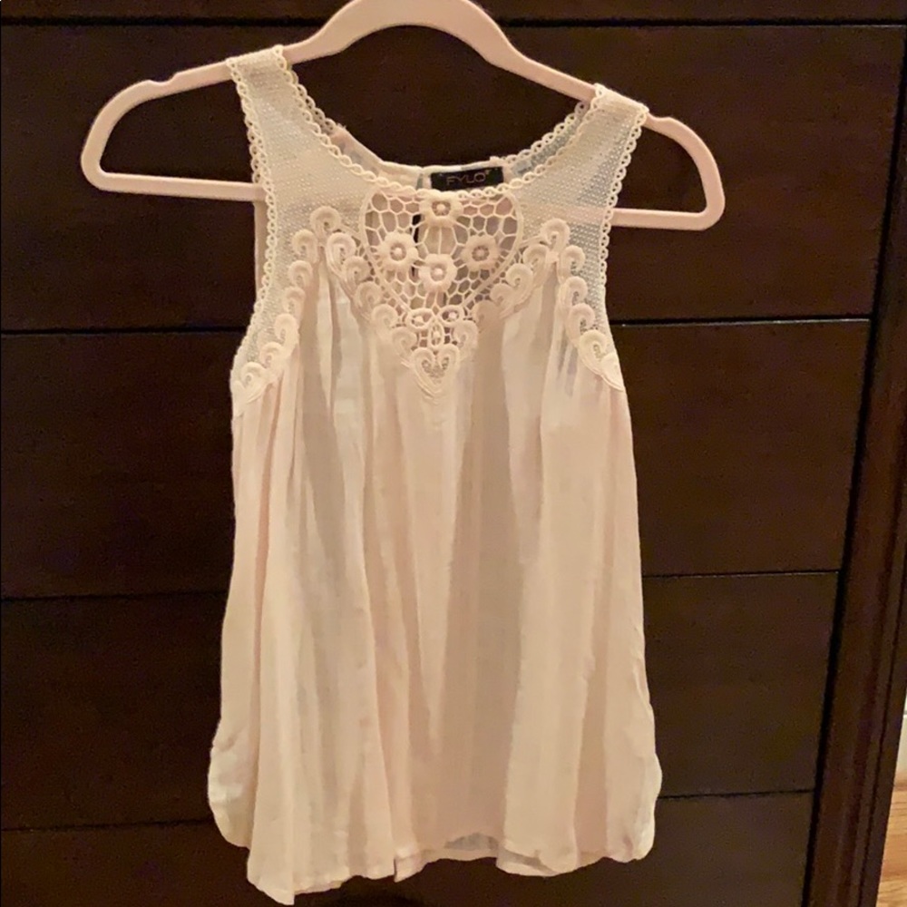 Sleeveless, pale pink shirt. Only worn once.